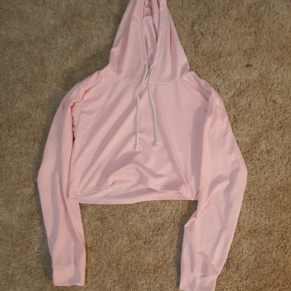 A cropped pink hoodie